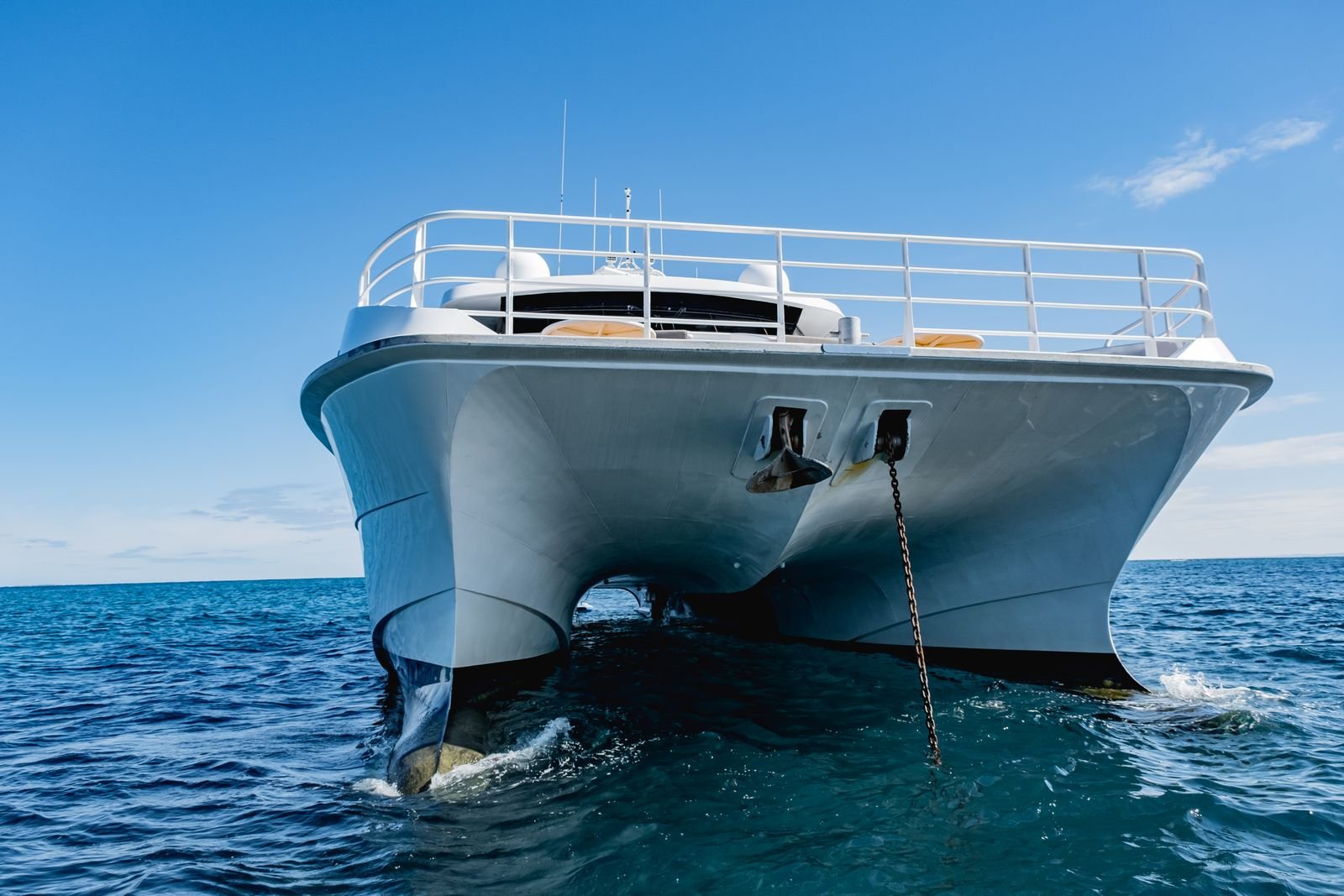 The wide forward deck and bow lounge aboard a sailing catamaran