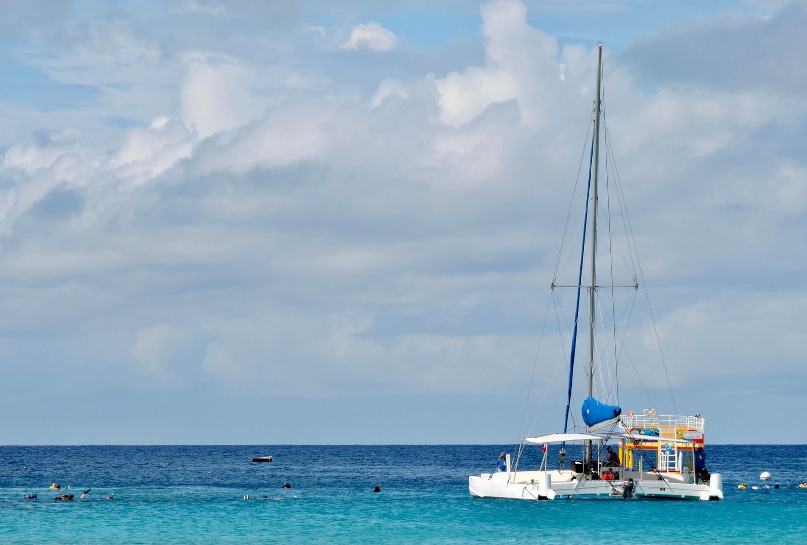 Fathom sailing catamaran moving through turquoise Caribbean water