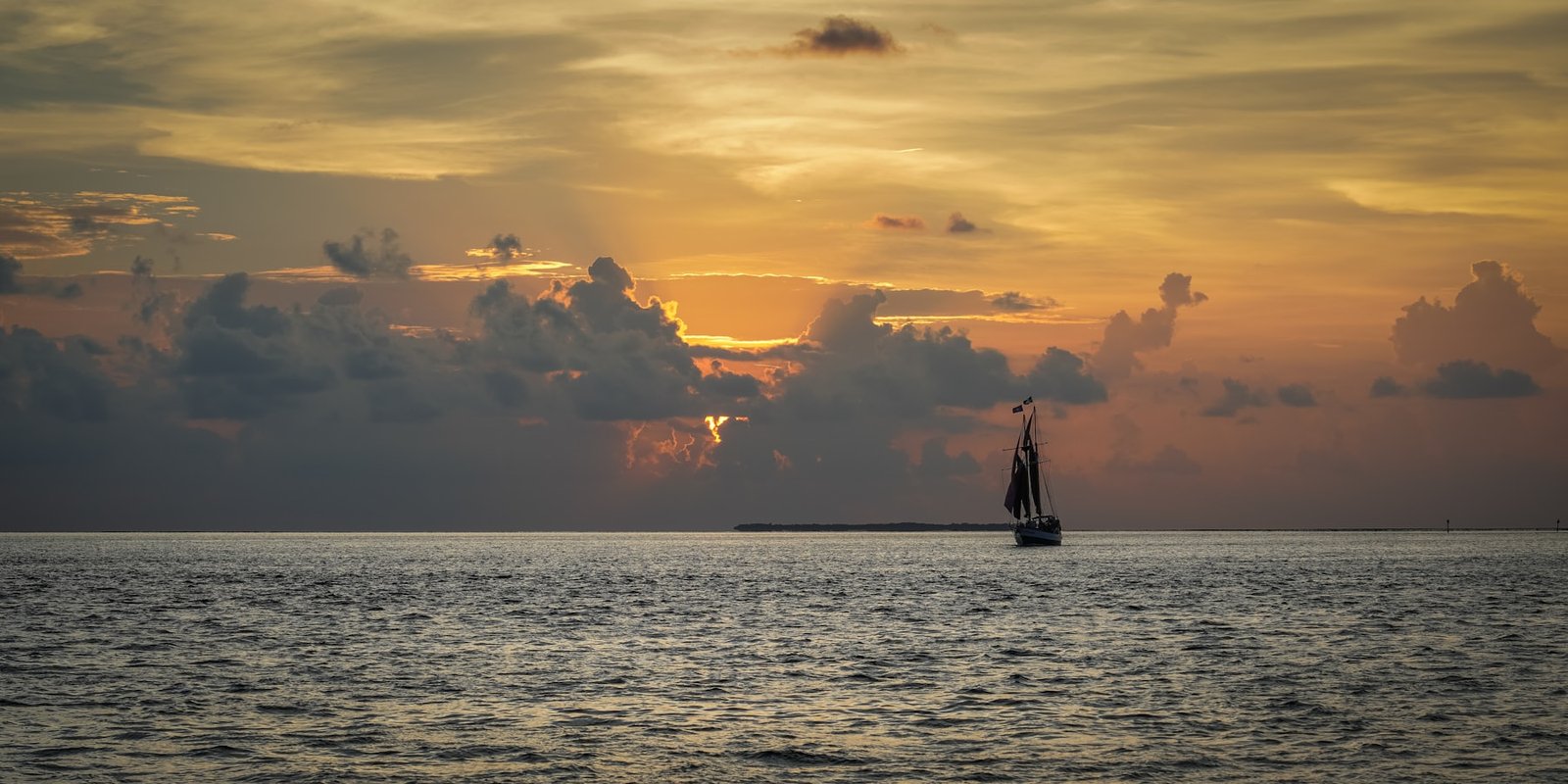 Sailboat silhouetted by a Key West sunset